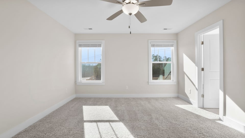 Bedroom with carpet and window.