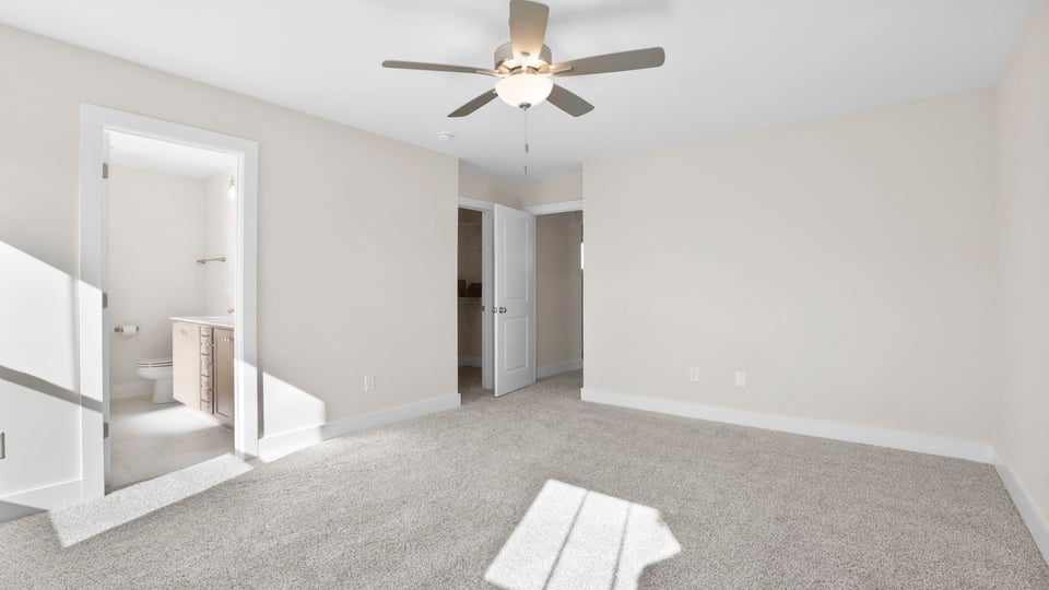 Bedroom with carpet and window.