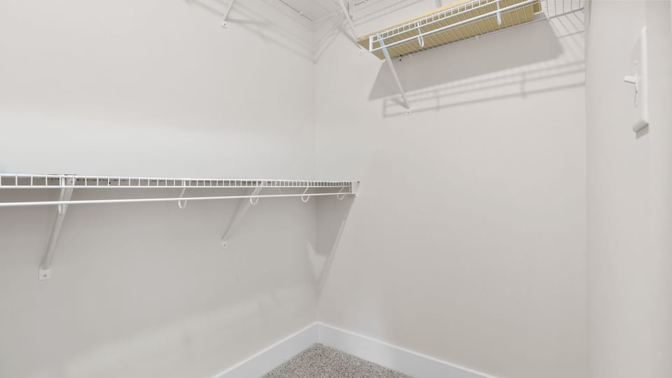 Walk in closet with shelves.