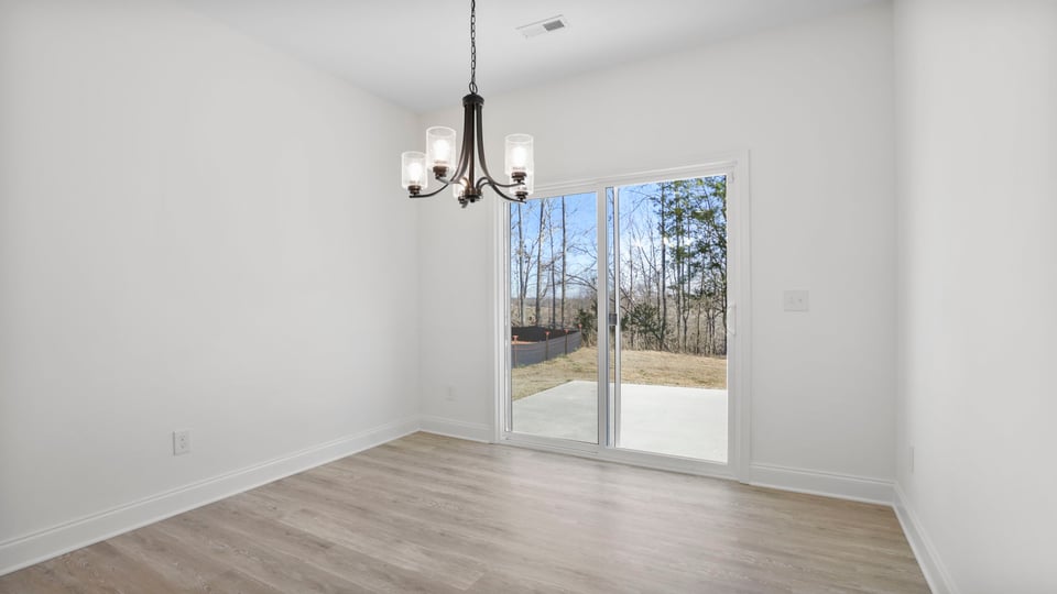 Dining room with chandelier and sliding doors.