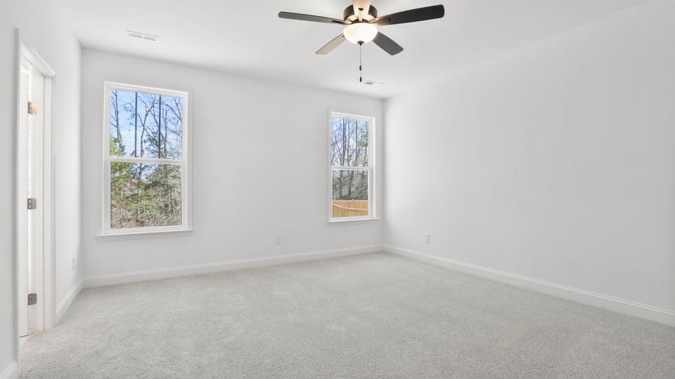Bedroom with carpet and window.