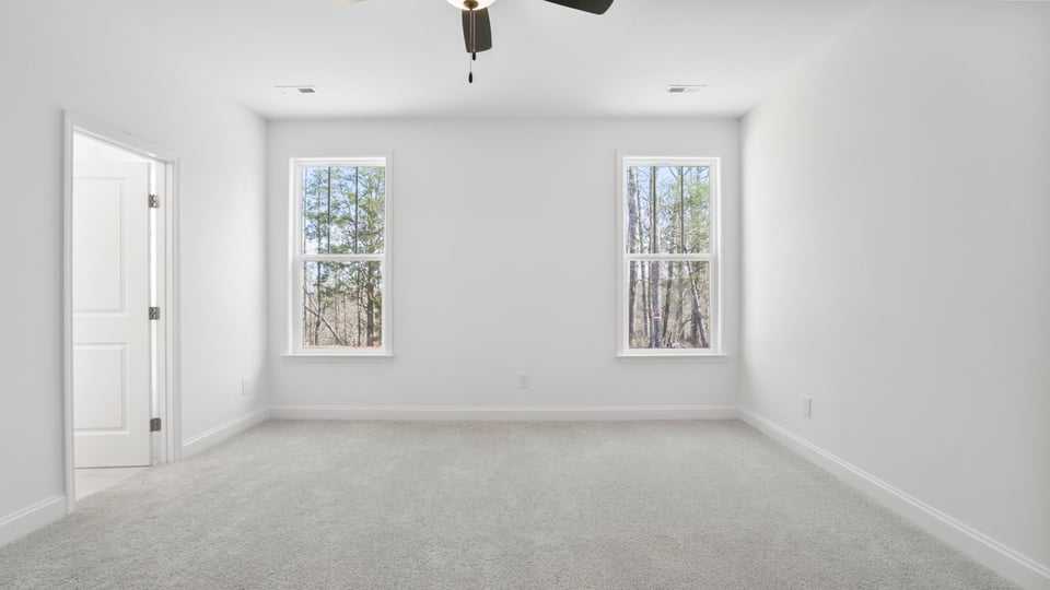 Bedroom with carpet and window.