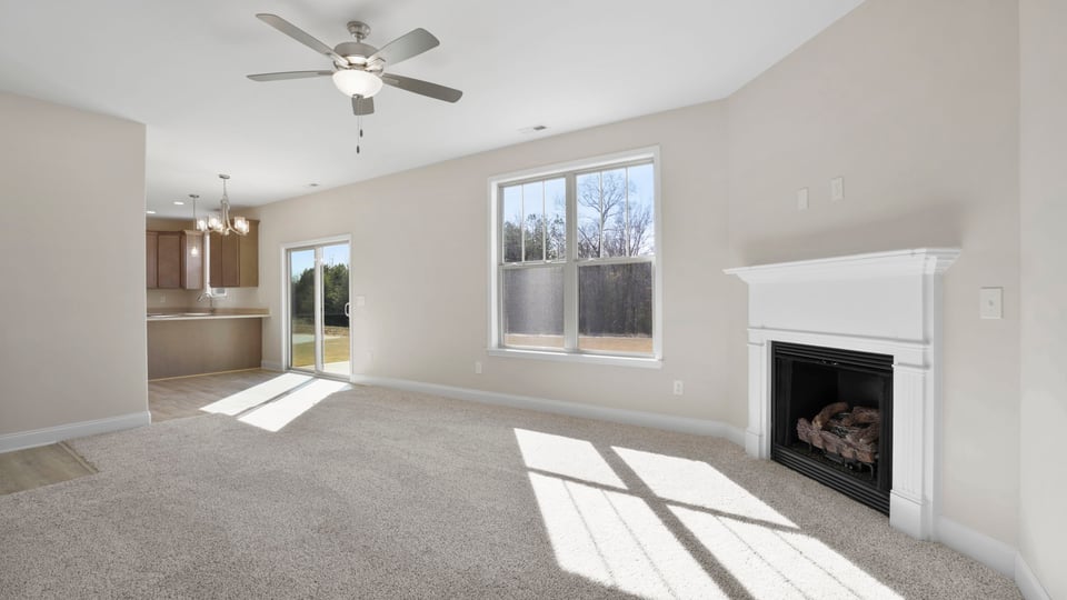 Living room with windows and fireplace.