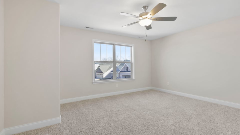 Bedroom with carpet and window.