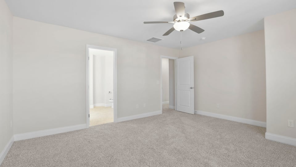 Bedroom with carpet and ceiling fan.