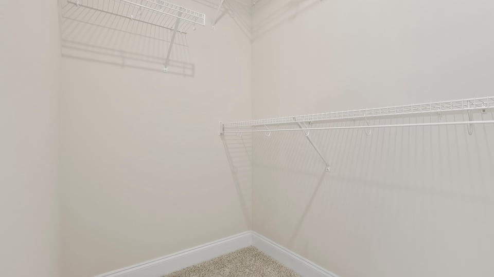Walk in closet with shelves.