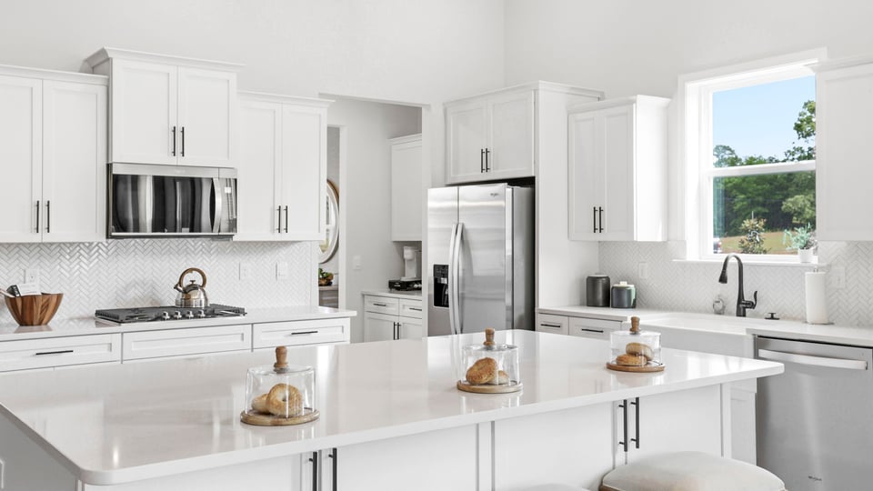 Kitchen with quartz countertops and island.