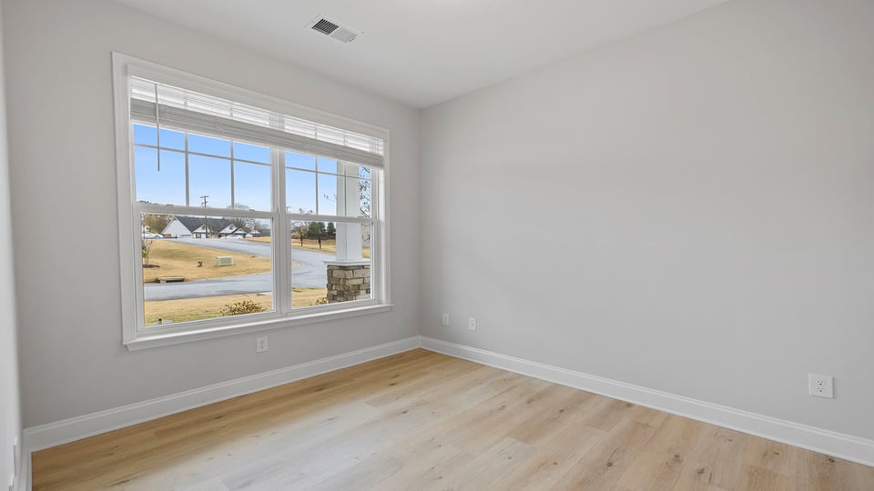 Bedroom with carpet and window.