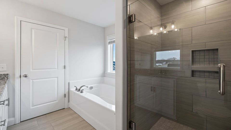 Bathroom with walk in shower and tub.
