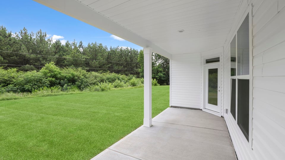 Back exterior of home with patio.