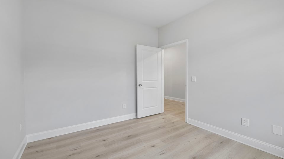 Bedroom with carpet and window.