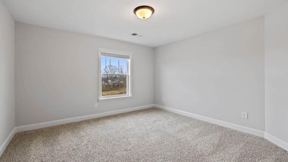Bathroom with carpet and windows.