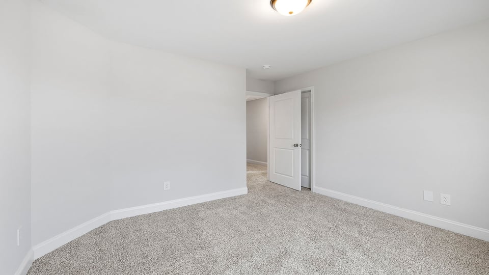 Bathroom with carpet and windows.