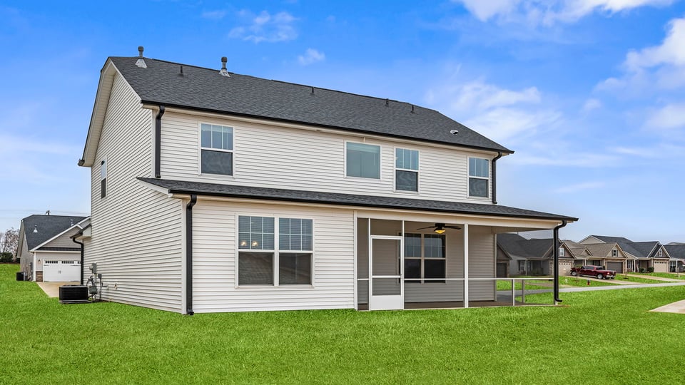 Exterior of home with large backyard.