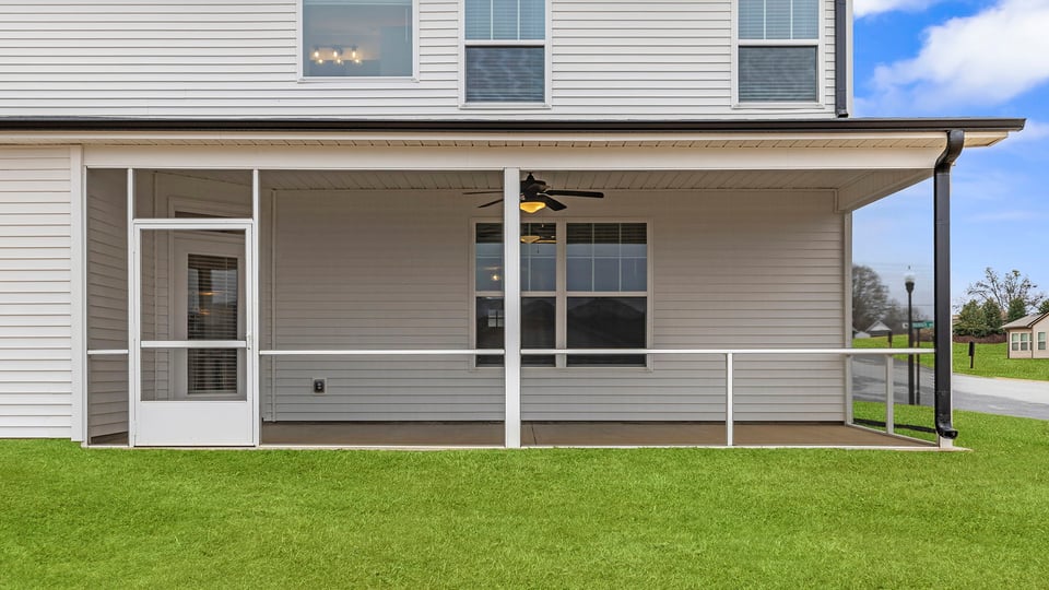 Exterior of home with large backyard.