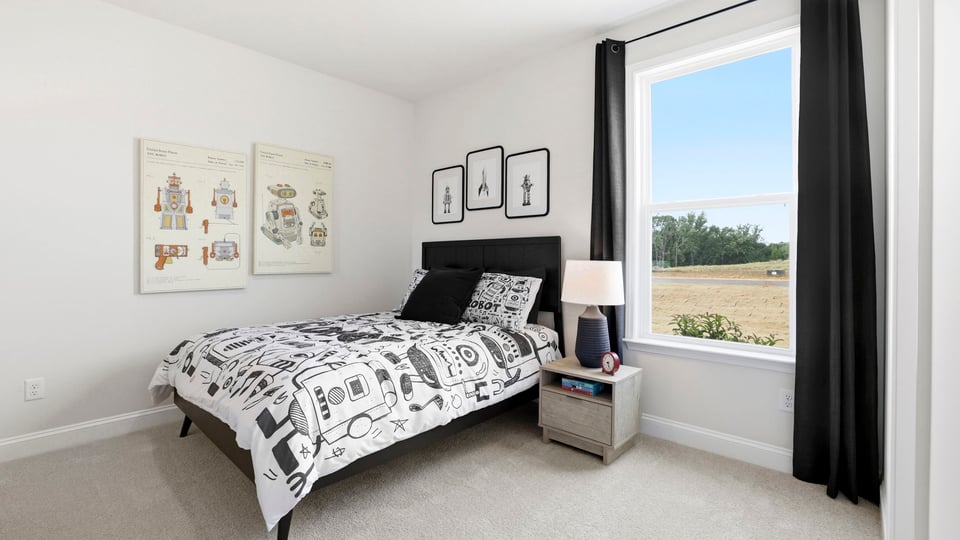 Bedroom with carpet and large window.