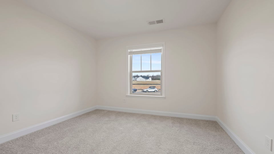 Bedroom with carpet and window.