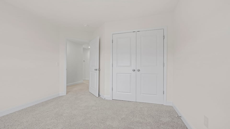 Bedroom with carpet and window.