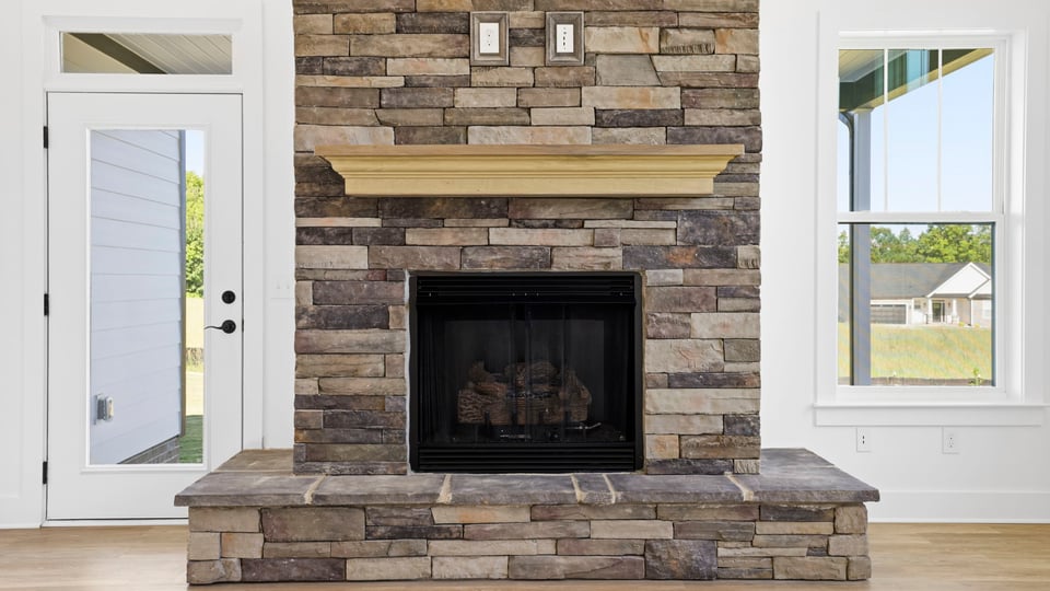 Livingroom with fireplace and windows.
