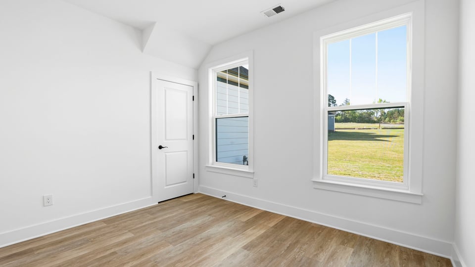 Bedroom with carpet and windows.