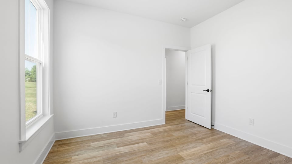 Bedroom with carpet and windows.