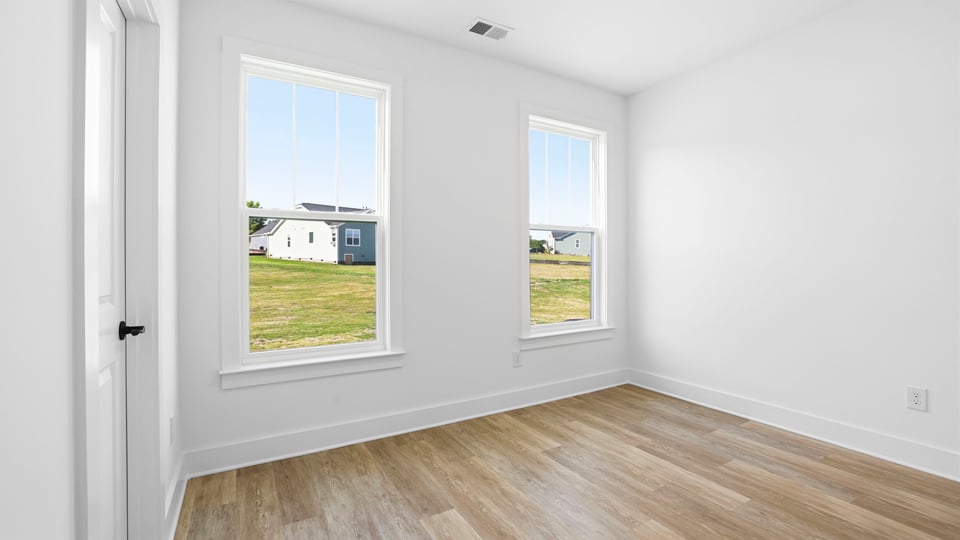 Bedroom with carpet and windows.