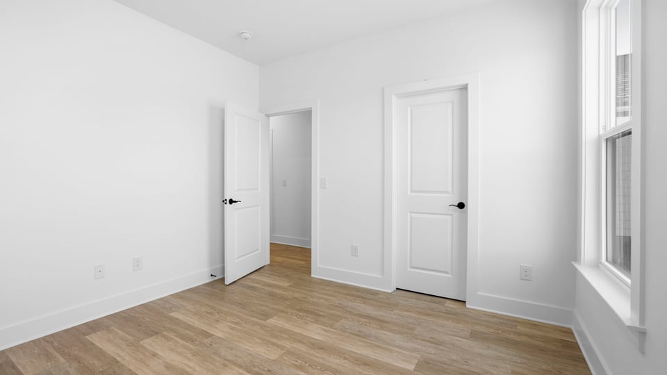Bedroom with carpet and windows.