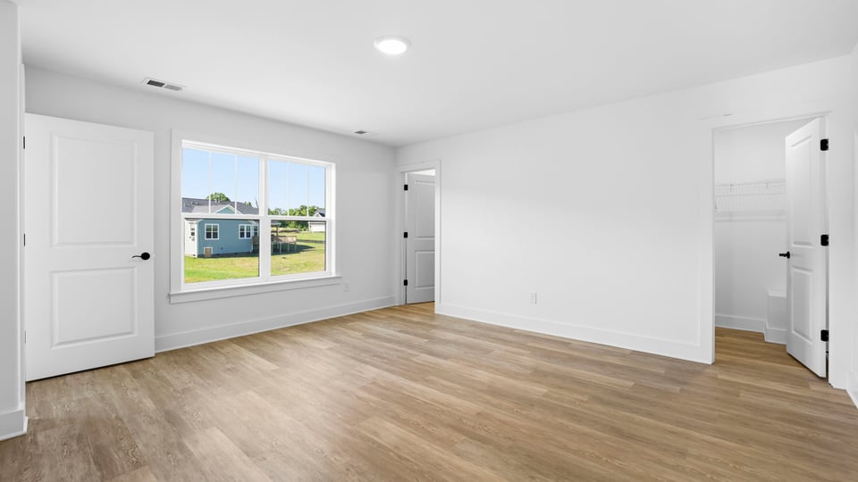 Bedroom with carpet and windows.