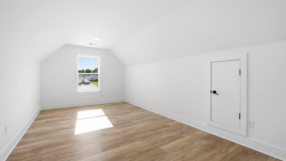 Bedroom with carpet and windows.