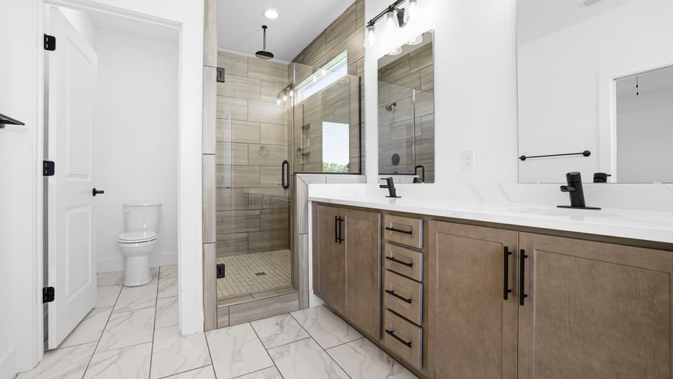 Bathroom with vanity and walk in shower.