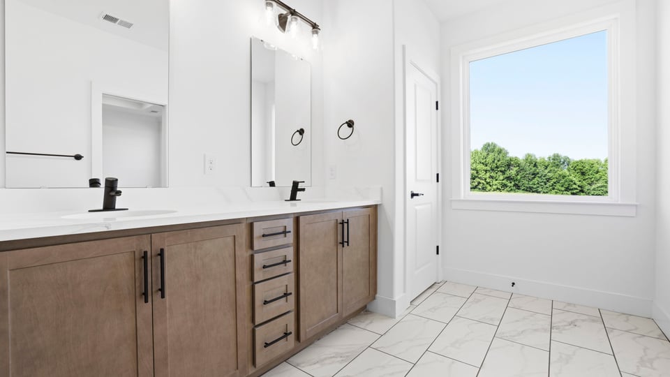 Bathroom with vanity and walk in shower.