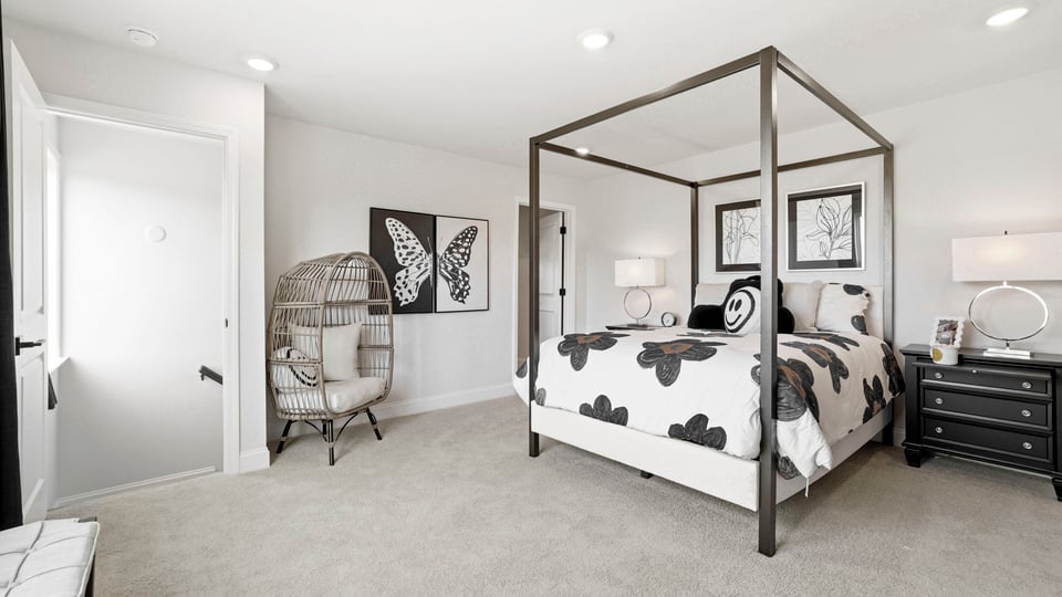Bedroom with carpet and large window.