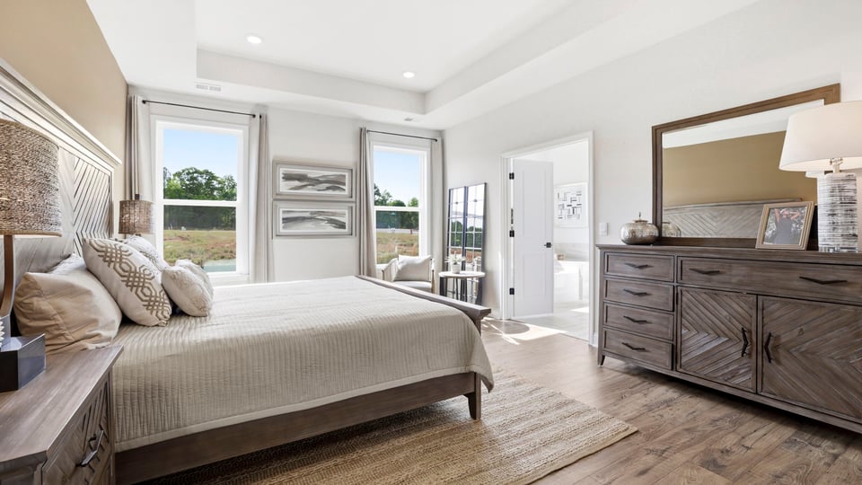 Primary bedroom with large windows.