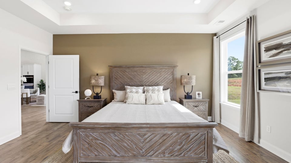 Primary bedroom with large windows.