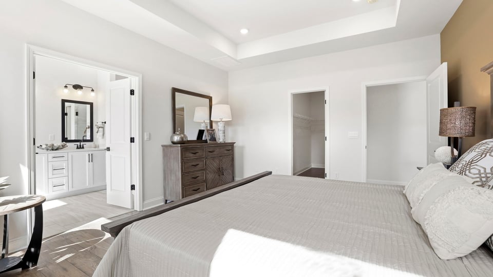 Primary bedroom with large windows.