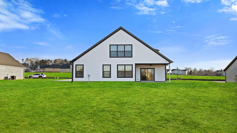 Back exterior of home with large backyard.