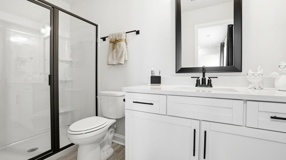 Bathroom with vanity and walk in shower.