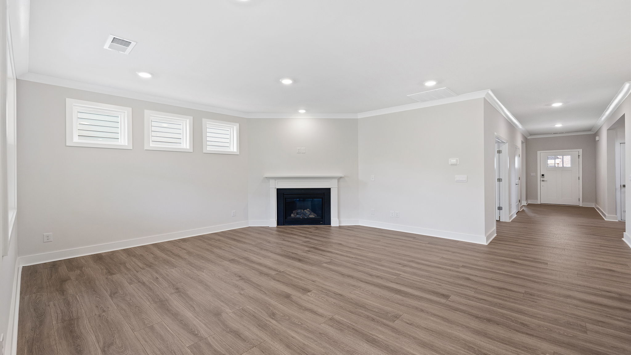 Living area with fireplace and windows.