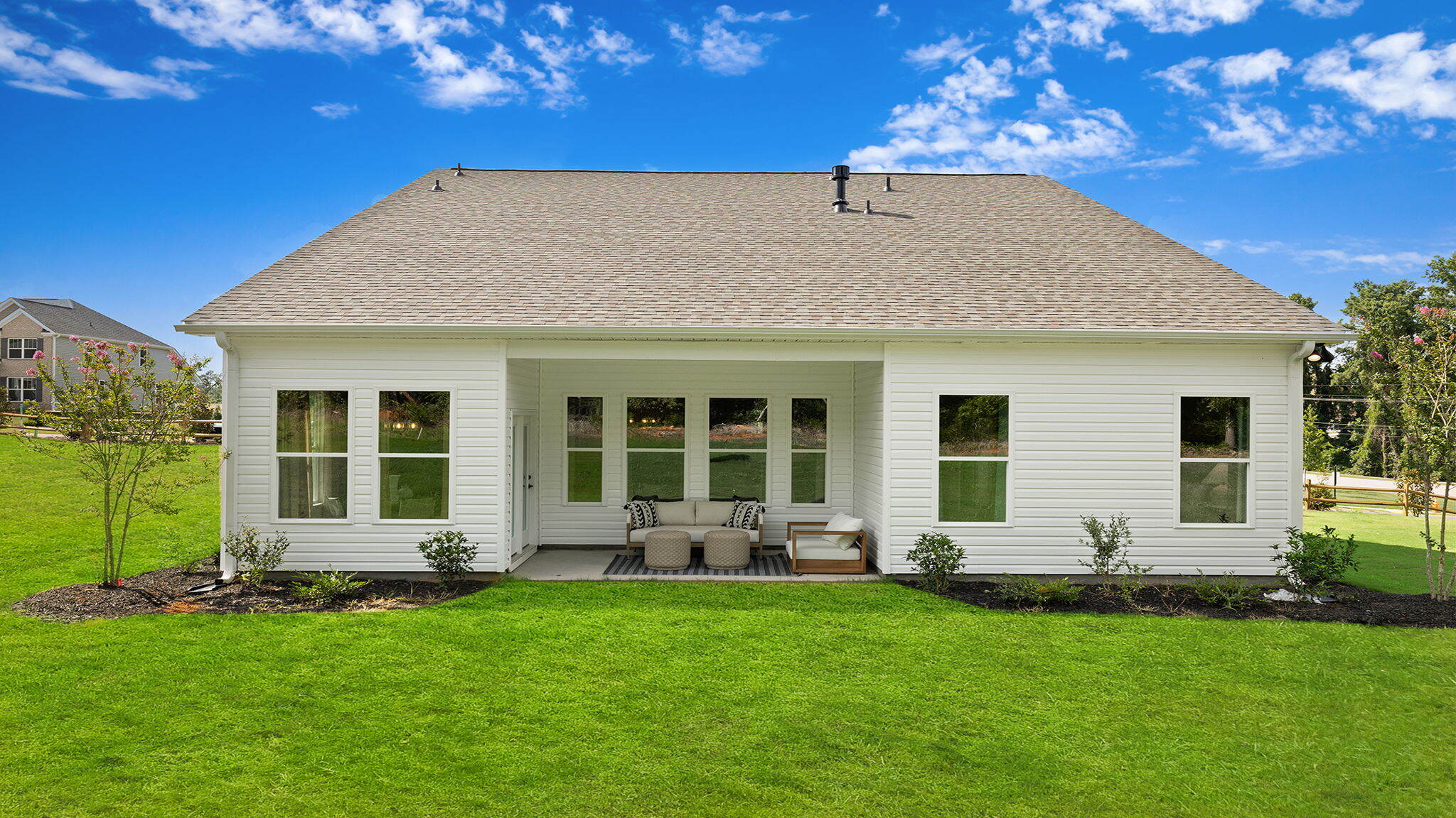 Covered back patio with large backyard.