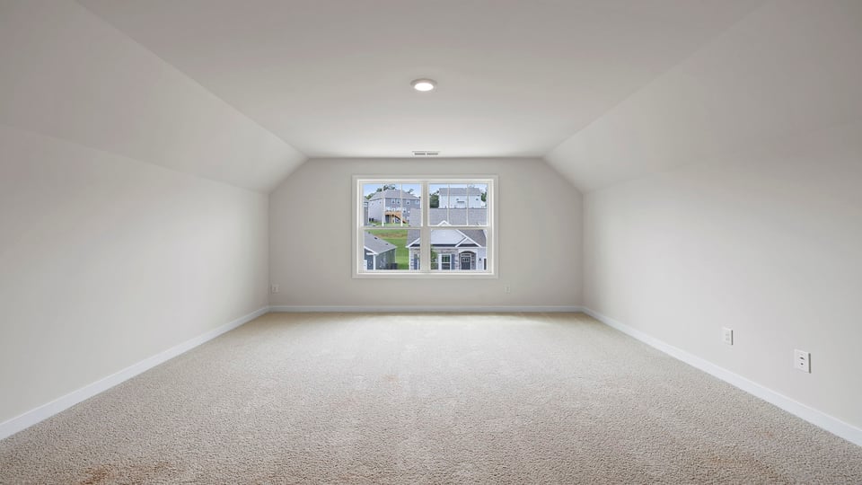 Loft area with carpet and window.
