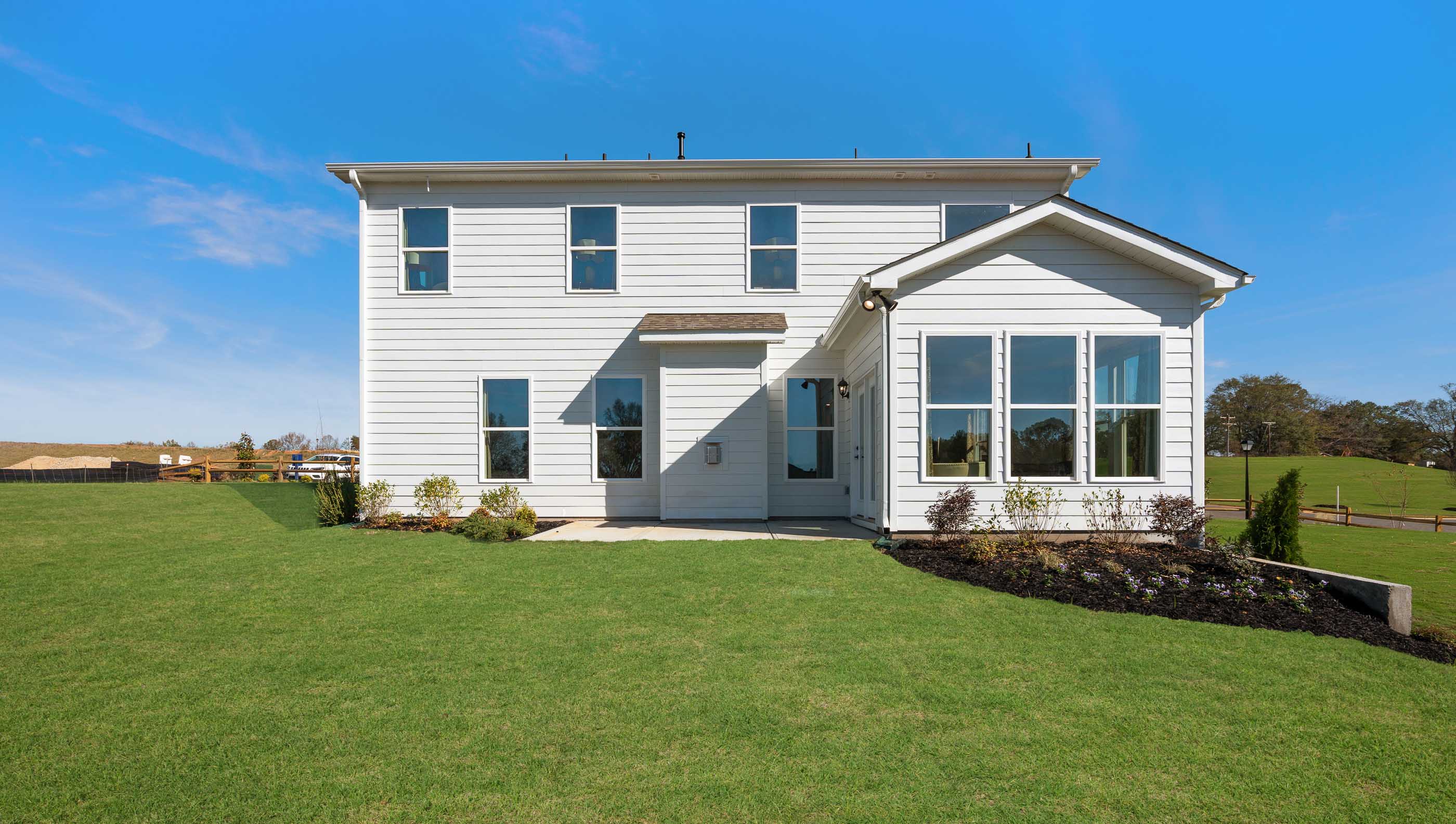 Back exterior with patio and large backyard.