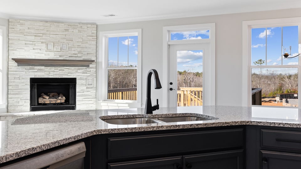 View of family room with gas log fireplace.lots of windows and gas log