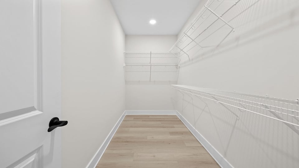 Primary bedroom walk in closet.