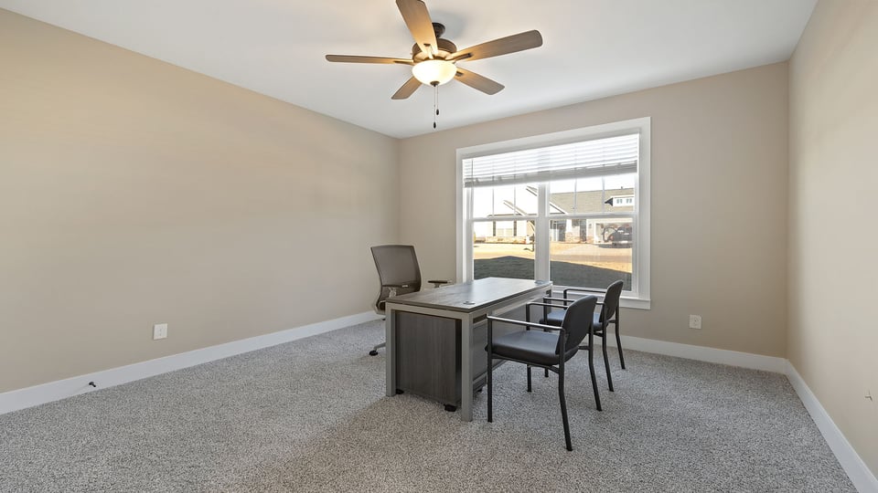 Bedroom with carpet and windows.
