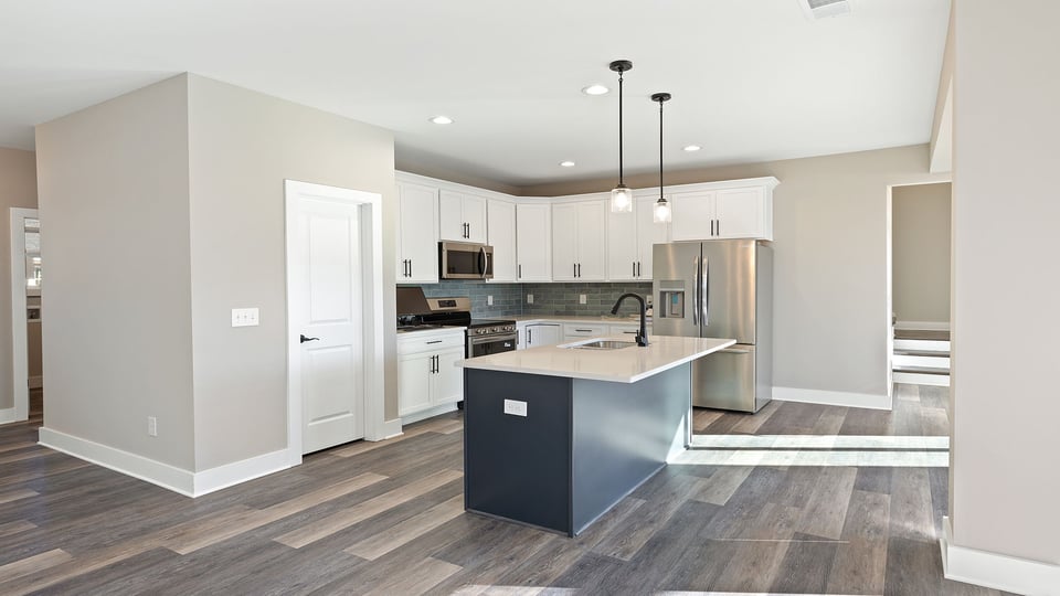 Kitchen with island and cabinets.