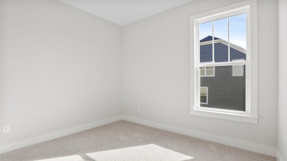 Bedroom with window and carpet.