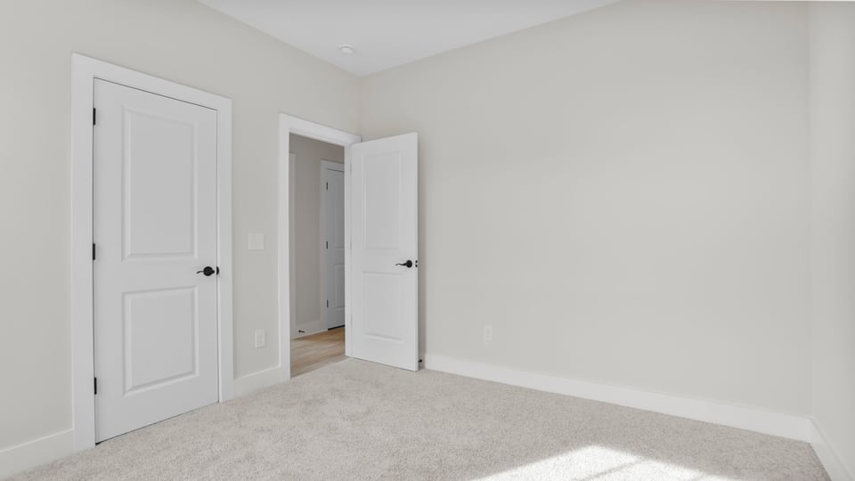 Bedroom with window and carpet.