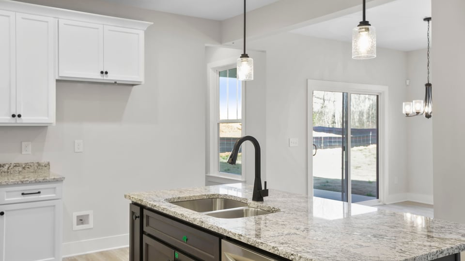 Kitchen and island feature quartz countertops and stainless-steel appliances.