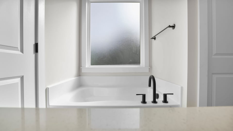 Primary bathroom with dual sink vanity, garden tub and walk-in shower.