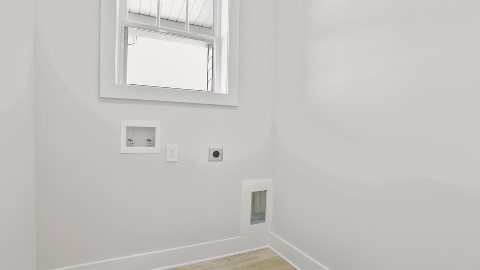 Walk-in laundry room with window.